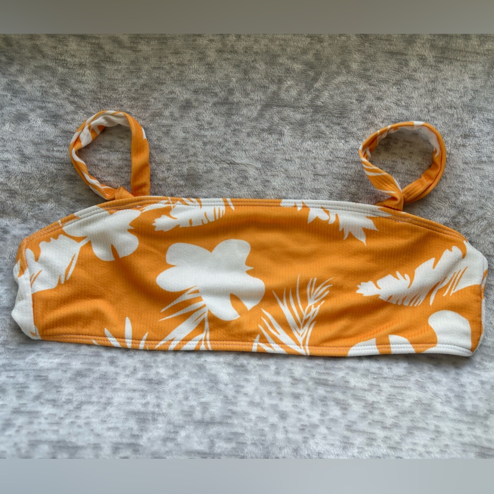 Very colorful and floral orange and white bikini top.